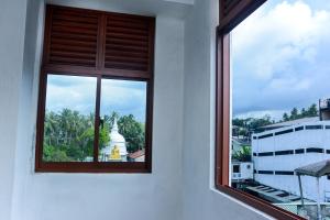 a window with a view of a temple at SEVENTY SEVEN GALLE in Galle