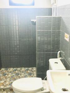 a bathroom with a toilet and a sink at Saeng Tai Amphawa in Samut Songkhram