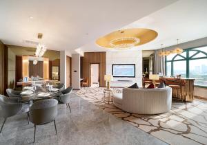 a living room with a table and chairs and a dining room at Sunway Resort Hotel in Kuala Lumpur