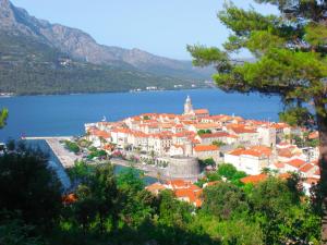 a town on the shore of a body of water at Eco Sunshine Apartments Lumbarda in Lumbarda