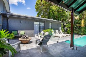 an outdoor patio with chairs and a table and a pool at Summerlea - Pet Friendly with Swimming Pool in Berry