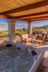 a hot tub on a patio with a view of the desert at Wolfkop Nature Reserve in Citrusdal