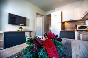 a christmas wreath on a wooden table in a kitchen at Apartments Francka in Bohinj