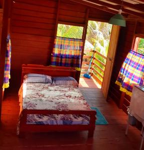 a bedroom with a bed in a wooden house at Reset in Zanderij