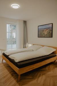 a large bed in a room with a window at Ferienwohnungen an der Salvatorkirche - Exklusiv-Apartments mit Terrasse in Coburg