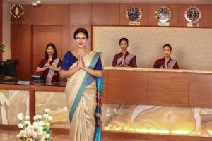 a woman in a sari standing in a lobby at Hotel Oil Field in Duliajan