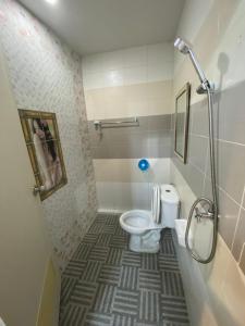 a small bathroom with a toilet and a shower at NB Bangsaen House in Ban Puk (2)