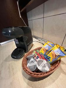 a basket filled with keys and a remote control at Oscar's Apartment in Floreşti +3 photos
