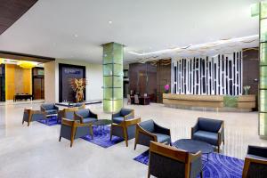 a lobby of a hotel with chairs and tables at ASTON Jember Hotel & Conference Center in Jember