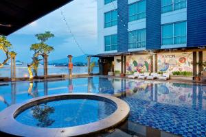 a large swimming pool in front of a building at ASTON Jember Hotel & Conference Center in Jember