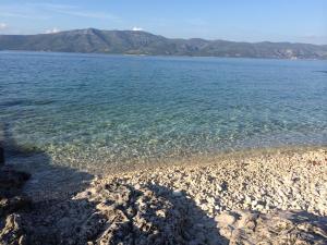 a large body of water with a rocky shore at Eco Sunshine Apartments Lumbarda in Lumbarda