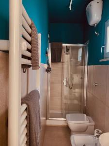a bathroom with a toilet and a shower with blue walls at Dolce Nera B&B in Narni Scalo