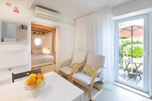 a bedroom with a bed and a table with a bowl of fruit at Apartments Mario 2 in Pula