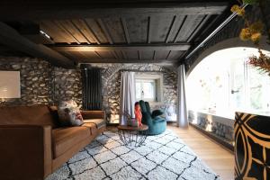 a living room with a couch and a table at Ferienresidenz von Planta in Pratval