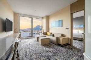a hotel room with a bed and a large window at Hyatt Place New Taipei City Xinzhuang in Xinzhuang