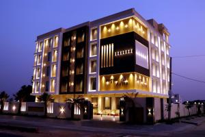 a large building with lights on it at night at Hotel Aarna in Jaipur
