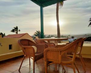 a patio with a table and chairs on a balcony at Mirador de Sotavento Apartment 8206 in Costa Calma
