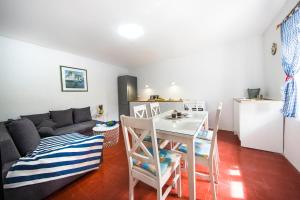 a living room with a couch and a table at House Sanja in Gdinj