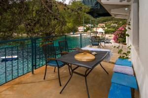 a patio with a table and chairs on a balcony at House Sanja in Gdinj