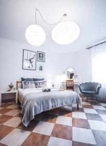 a bedroom with a bed and a checkered floor at LION apartments - Your own apartment in Cracow in Krakow