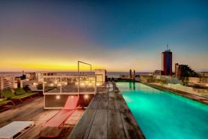 a swimming pool on the roof of a building at IKYK Hotel- IK Collection in St Julian's