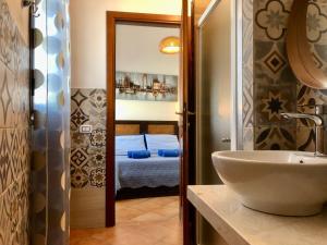 a bathroom with a sink and a mirror at Casa Bea B&B in Tortolì