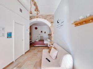 a living room with a couch and a bedroom at Casa vacanze LaCorte ByFrancy in Bari
