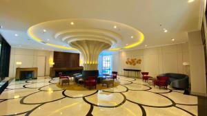 a lobby with a large room with a large ceiling at Maia Hotel Jakarta in Jakarta