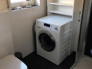 a washer and dryer in a small room at Ankerhaus in Zinnowitz +16 photos