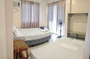 a hotel room with two beds and a window at Solsken Guest House in Bantayan Island