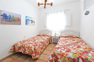 a bedroom with two beds and a window at Casa La Caleta in Los Llanos de Aridane +8 photos