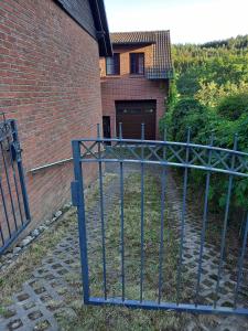 an iron gate in front of a brick building at Appartement Spatzennest in Mossautal