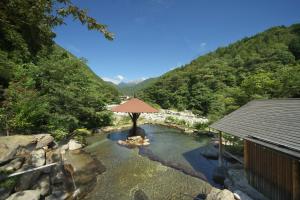 高山市にある穂高荘 山のホテルの山の中央にプールがあるリゾート