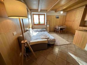 a bedroom with a bed and a table in a room at Tabia studio - Colle Santa Lucia in Villagrande