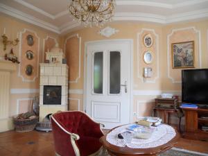 a living room with a table and a chandelier at Vila Mirjam in Radovljica