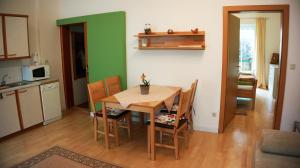 a kitchen and dining room with a table and chairs at Ferienwohnungen Weissenbacher in Mitterbach