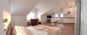 a living room with a bed and a kitchen at Apartamentos la Garita - Casa Miro y Marianita - Cudillero in Cudillero +9 photos