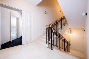 a staircase in a home with white walls and a door at Hotel Krupnicza 30 in Kraków