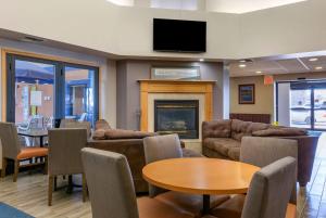 a living room with couches and a fireplace at Howard Johnson by Wyndham Billings in Billings