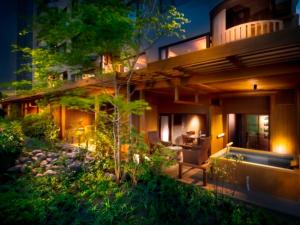 a house with a garden in front of it at night at Bessho Sasa in Fujiyoshida