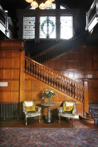 a staircase with two chairs and a table in a room at Elmbank Hotel - Part of The Cairn Collection in York