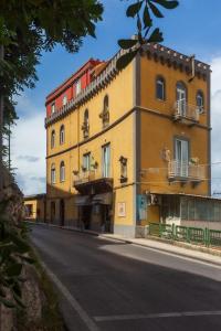 a large yellow building on the side of a street at Sorrento Tower in Sorrento