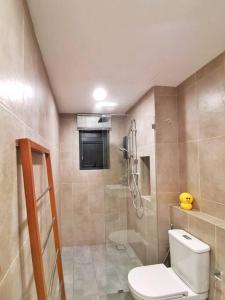 a bathroom with a shower and a toilet and a sink at Timurbay Beach Resort Balok Kuantan in Kampung Sungai Karang