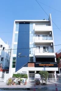 a tall building with a sign in front of it at Regal Suites in Bengaluru