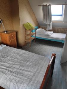 a bedroom with two beds and a window at IDAVRO in Saint-Nicolas-du-Pélem