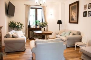 a living room with two couches and a table at Dwór Konstancin in Konstancin-Jeziorna
