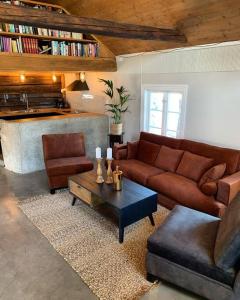 a living room with a couch and a coffee table at Morellgården in Larvik