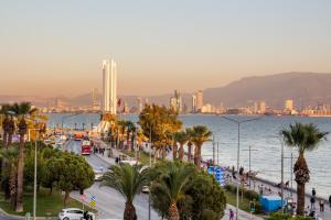 a city with palm trees and the water and buildings at Flat with Sea View near Karsiyaka Coast in Izmir