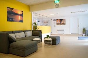 a living room with a couch and chairs and a table at Jugend- und Familiengästehaus Villach in Villach