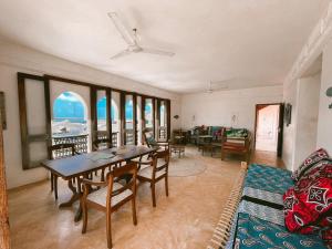 a living room with a table and chairs at Lamu penthouse Apartment in Lamu